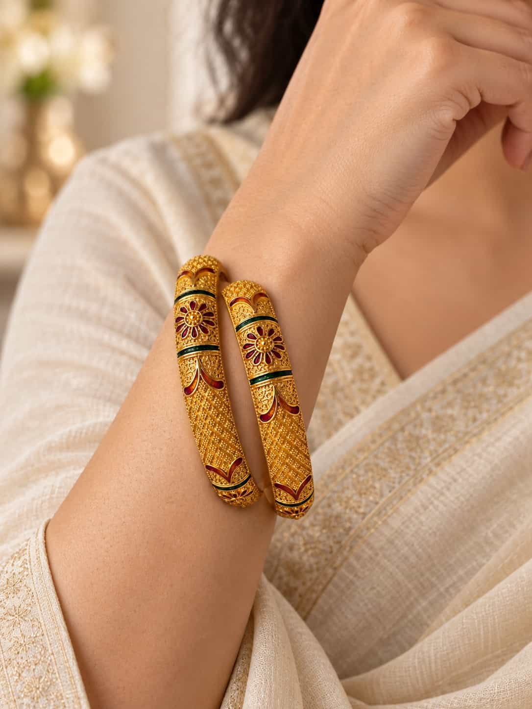 Woman wearing Zariya Heritage microgold enamel kada pair with an ivory ethnic outfit