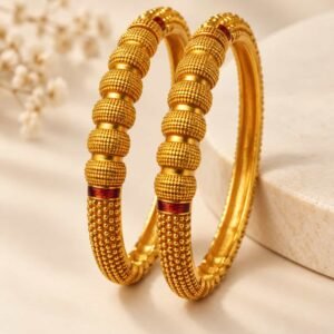 Noorika microgold kada set of 2 with beaded gold-tone design and red accents on neutral background