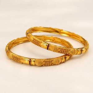 Two Aarika Heritage microgold bangles with gold-look textured motifs and maroon accents on a neutral background.